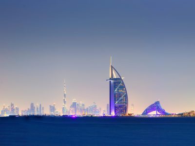 DUBAI - Nov 17: Skyline of Dubai at night with Burj al Arab in foreground. Nov 17, 2017 in Dubai, United Arab Emirates.